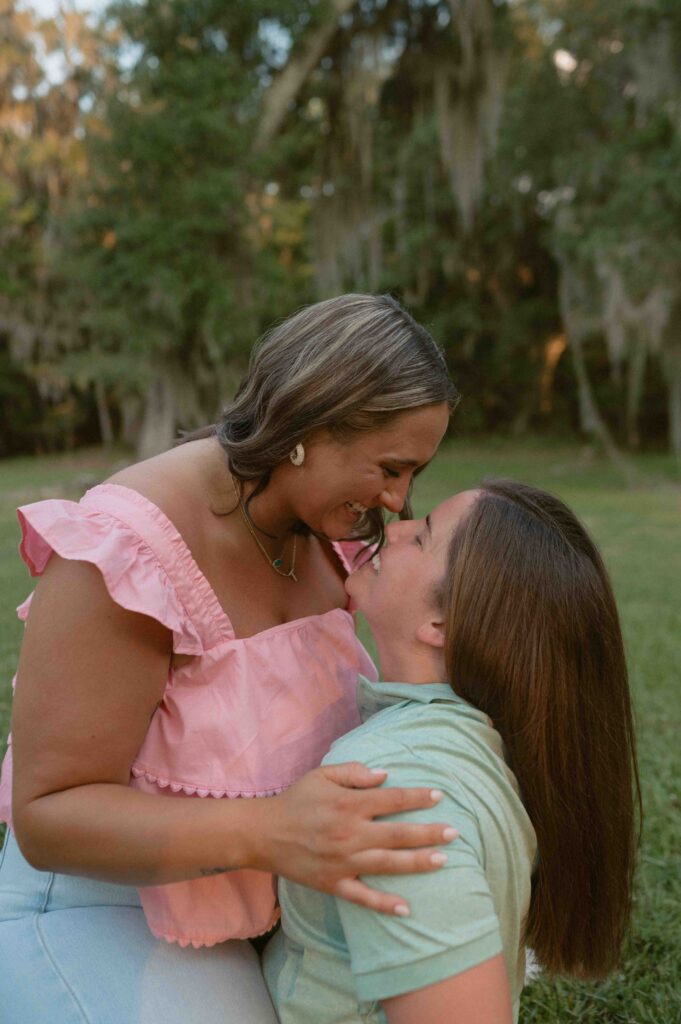 Lgbtq+ couple laughing during their engagement session.